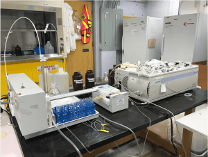 A Nutrient auto-analyzer. Vials are placed in racks in the loading mechanism at left, and then samples are automatically pumped into the thin. tubes moving towards the analyzer itself at right.